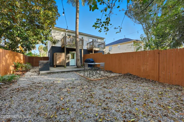 a backyard of a house with table and chairs