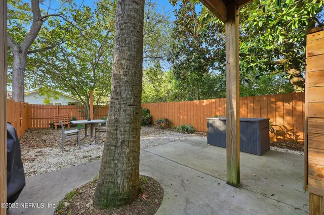 a backyard of a house with table and chairs