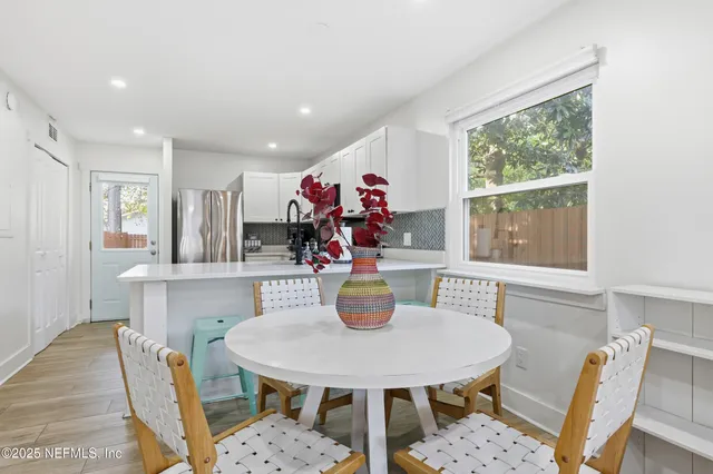 a view of a dining room with furniture and window