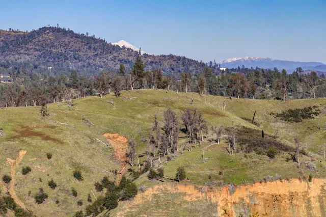 a view of a town with mountains in the background