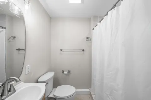 a white toilet sitting next to a bathroom sink