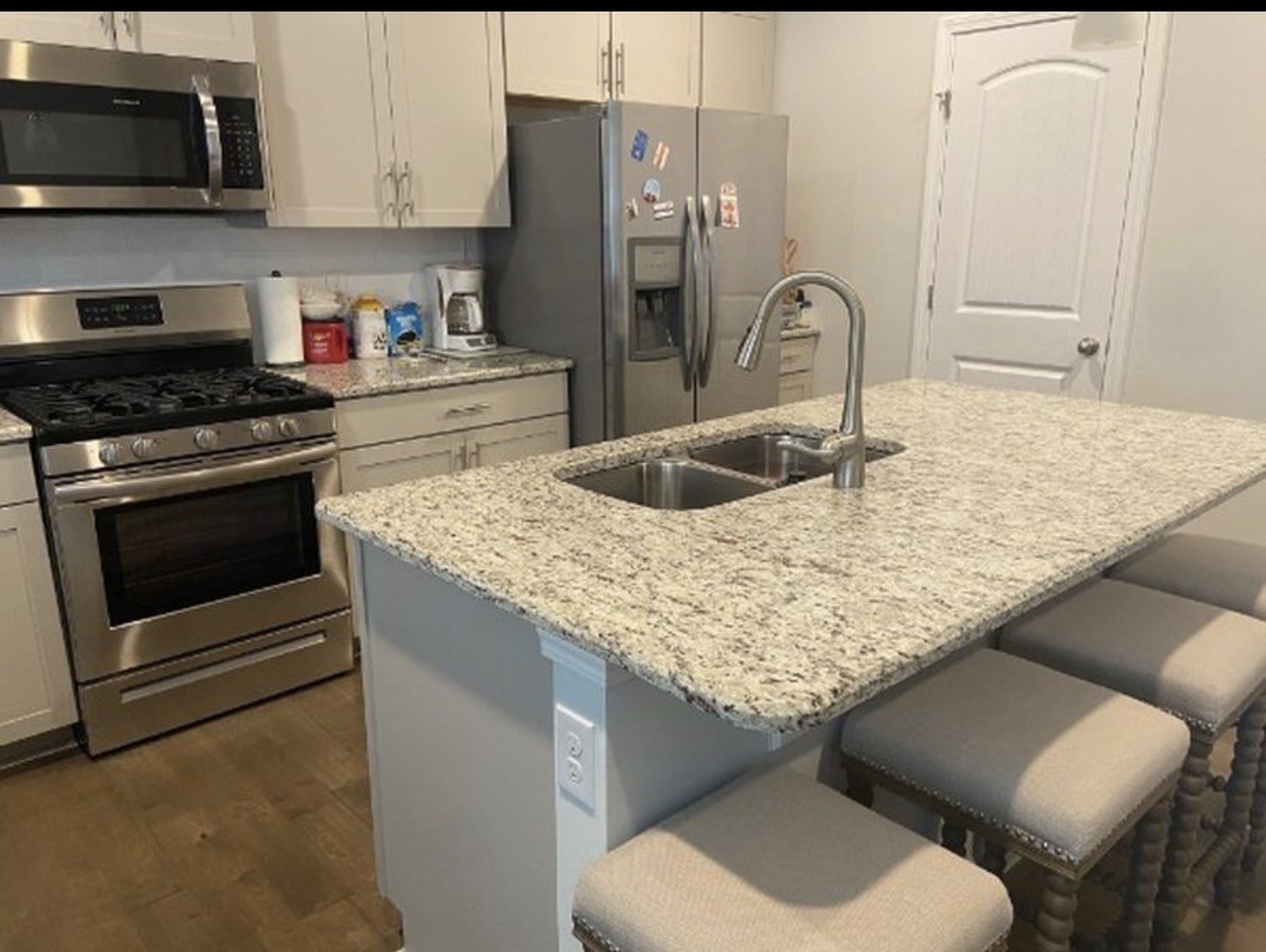 4107 Grapevine Loop Smyrna, TN 37167 - Photo 4 of 12 a kitchen with stainless steel appliances granite countertop a sink stove and microwave