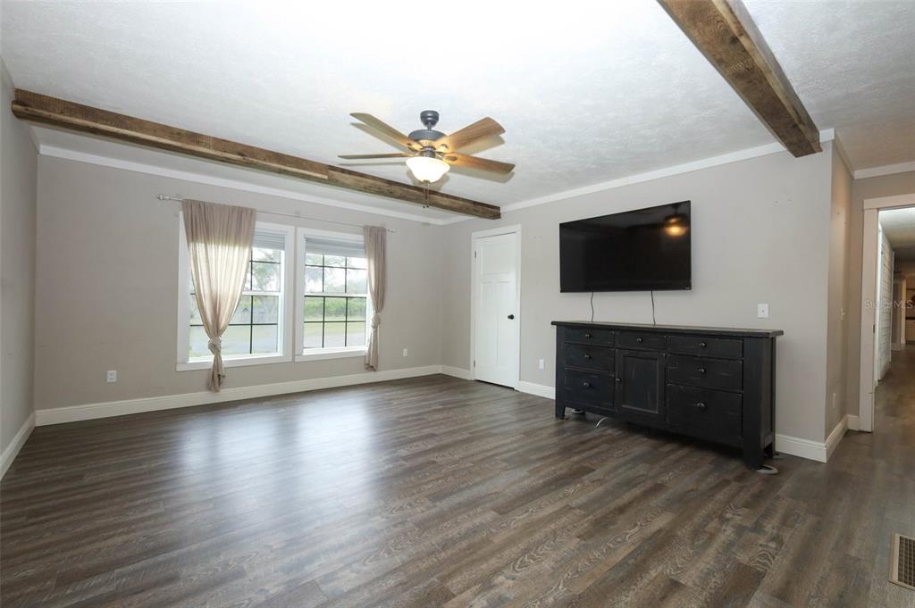2269 Mullet Lake Park Road Geneva, FL 32732 - Photo 21 of 76 a view of a livingroom with wooden floor and a flat screen tv