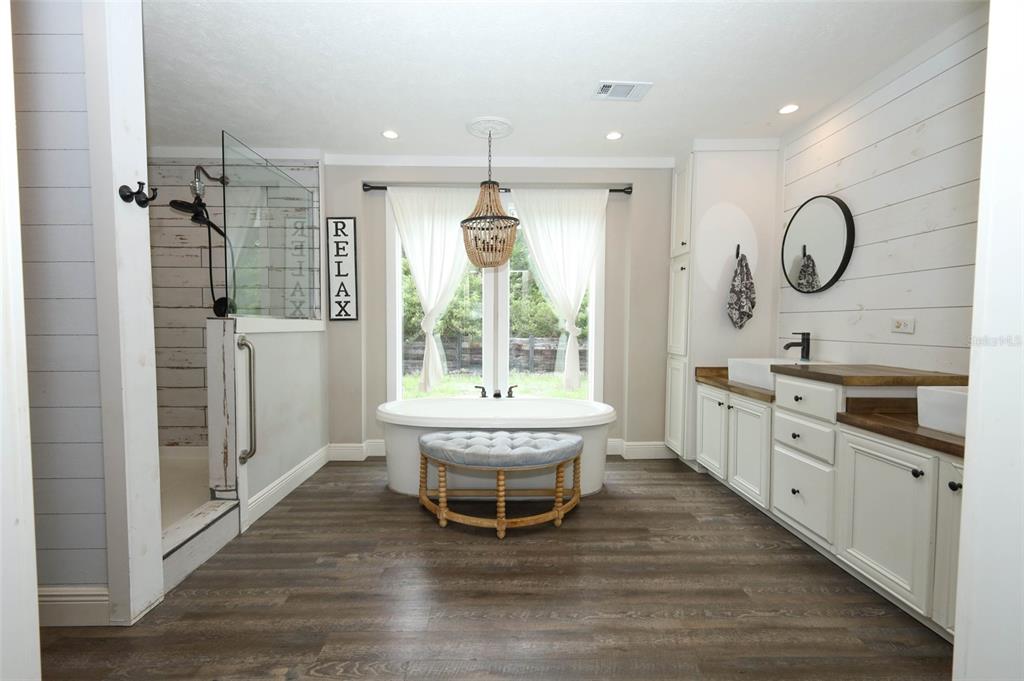 2269 Mullet Lake Park Road Geneva, FL 32732 - Photo 27 of 76 a spacious bathroom with a double vanity sink a large mirror and a bathtub