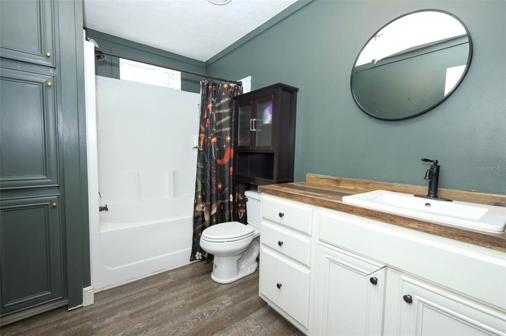 2269 Mullet Lake Park Road Geneva, FL 32732 - Photo 35 of 76 a bathroom with a toilet sink vanity and mirror