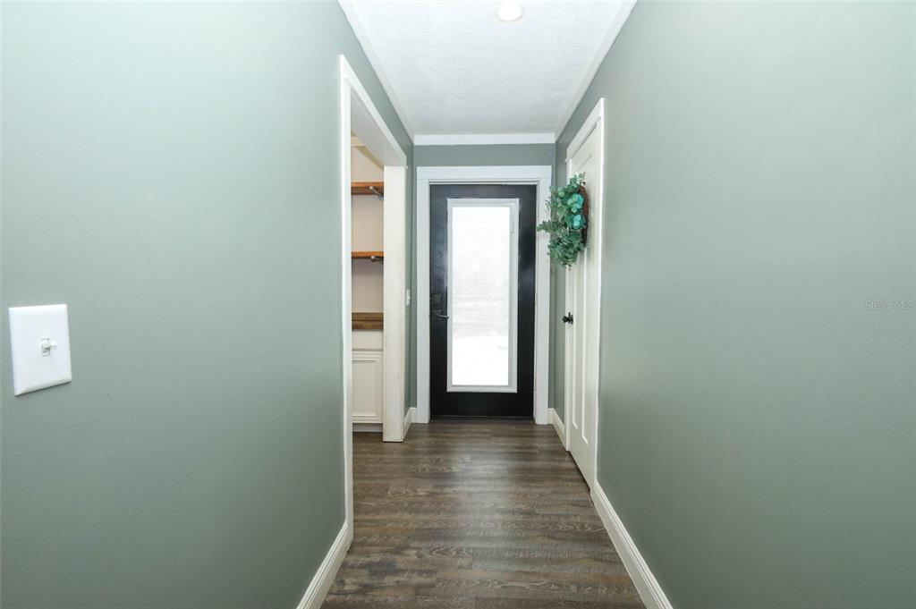 2269 Mullet Lake Park Road Geneva, FL 32732 - Photo 41 of 76 a view of a hallway with wooden floor and a bathroom