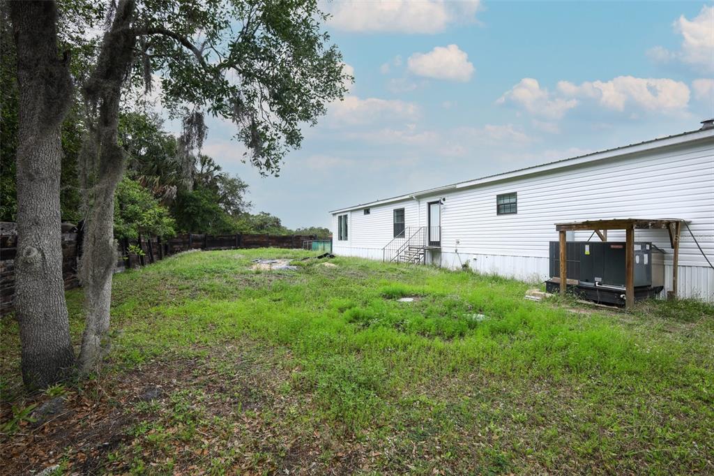 2269 Mullet Lake Park Road Geneva, FL 32732 - Photo 43 of 76 a view of backyard with barbeque grill and a big yard