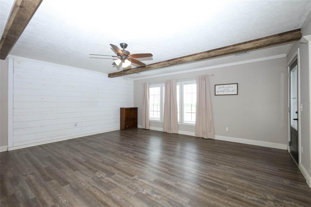 2269 Mullet Lake Park Road Geneva, FL 32732 - Photo 9 of 76 a view of an empty room with wooden floor and a window