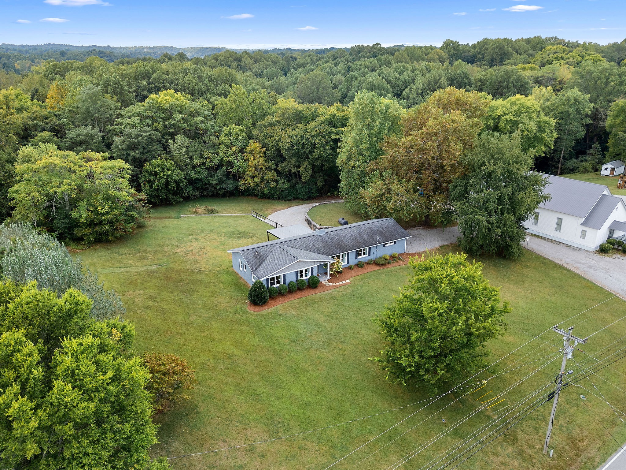 2337 Les Robinson Road Columbia, TN 38401 - Photo 2 of 42 a backyard of a house with a yard and outdoor seating