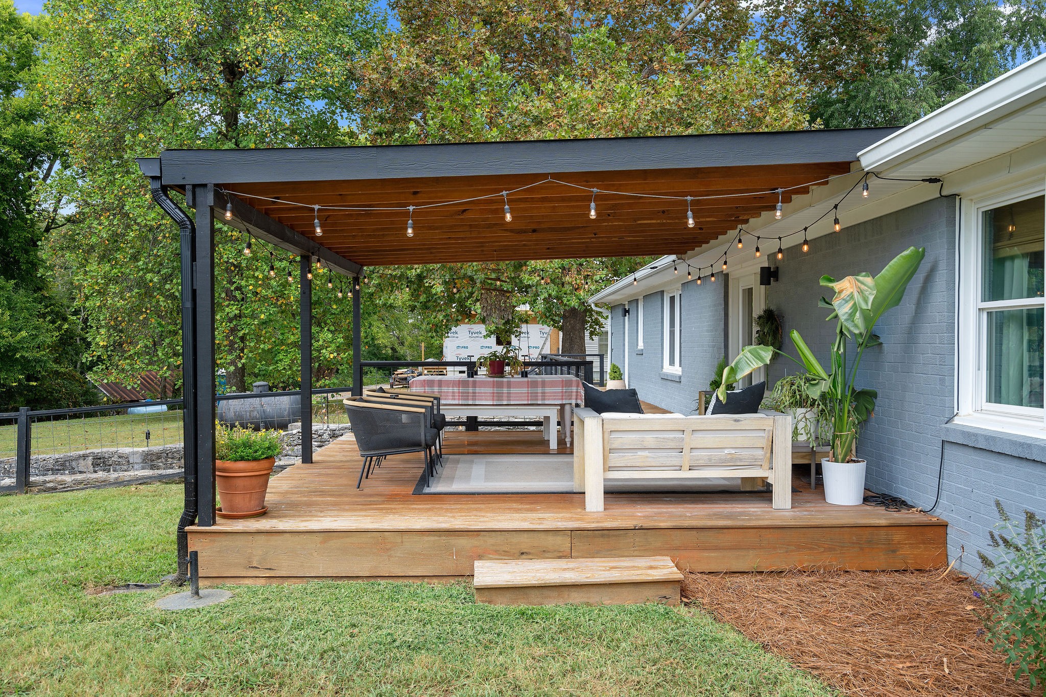 2337 Les Robinson Road Columbia, TN 38401 - Photo 32 of 42 a view of a patio with table and chairs potted plants with floor to ceiling window and wooden fence