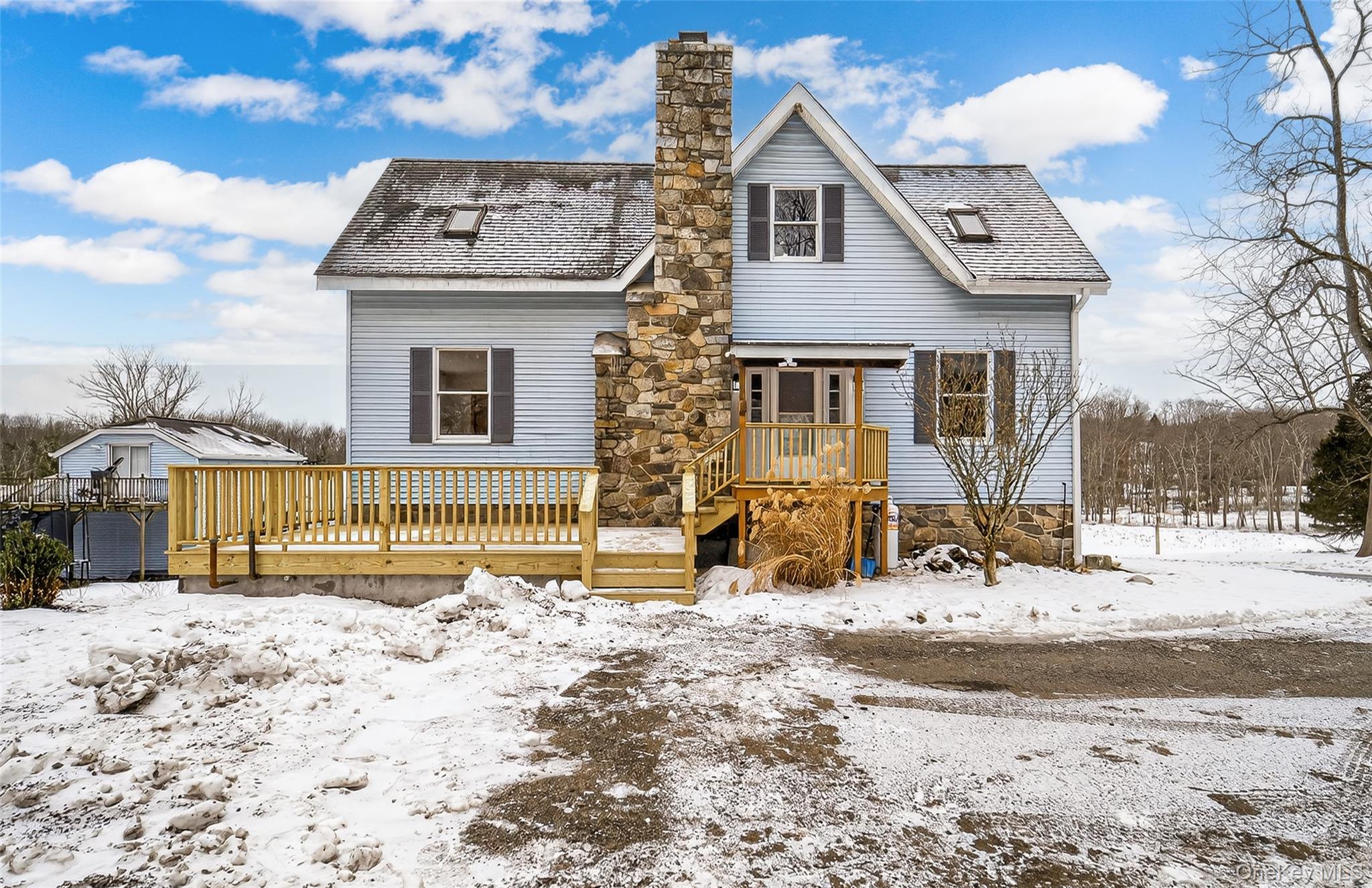 a view of a house with a yard covered in snow