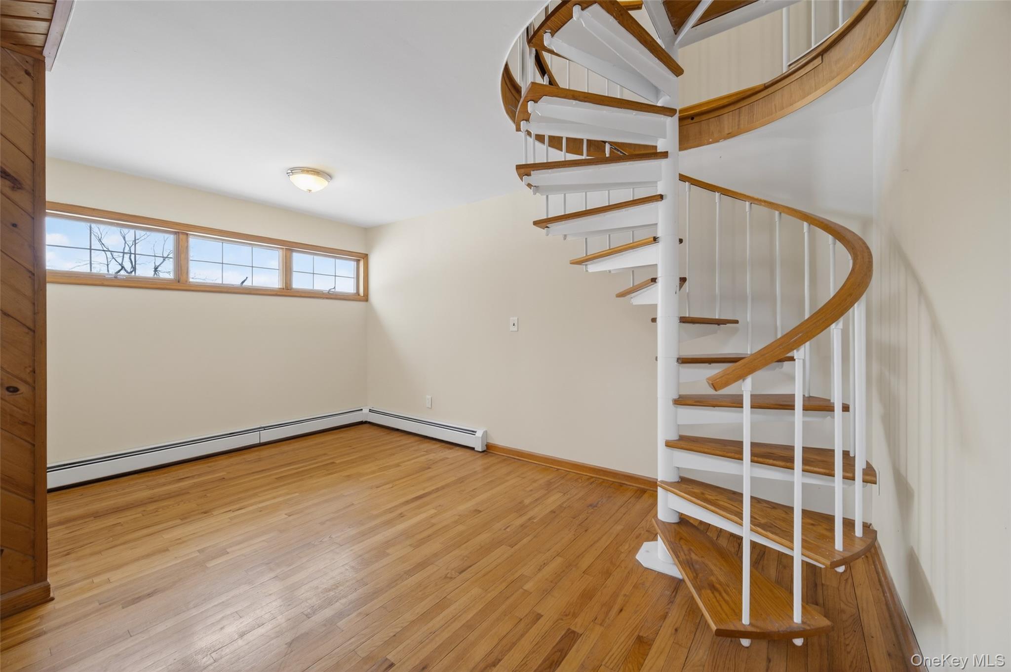 408 Bull Mill Road, Unit 2 Chester, NY 10918 - Photo 11 of 29 an empty room with wooden floor and windows
