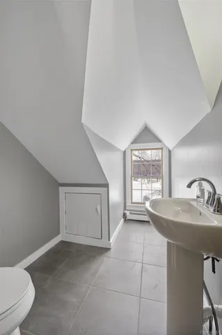 a spacious bathroom with a sink toilet and window