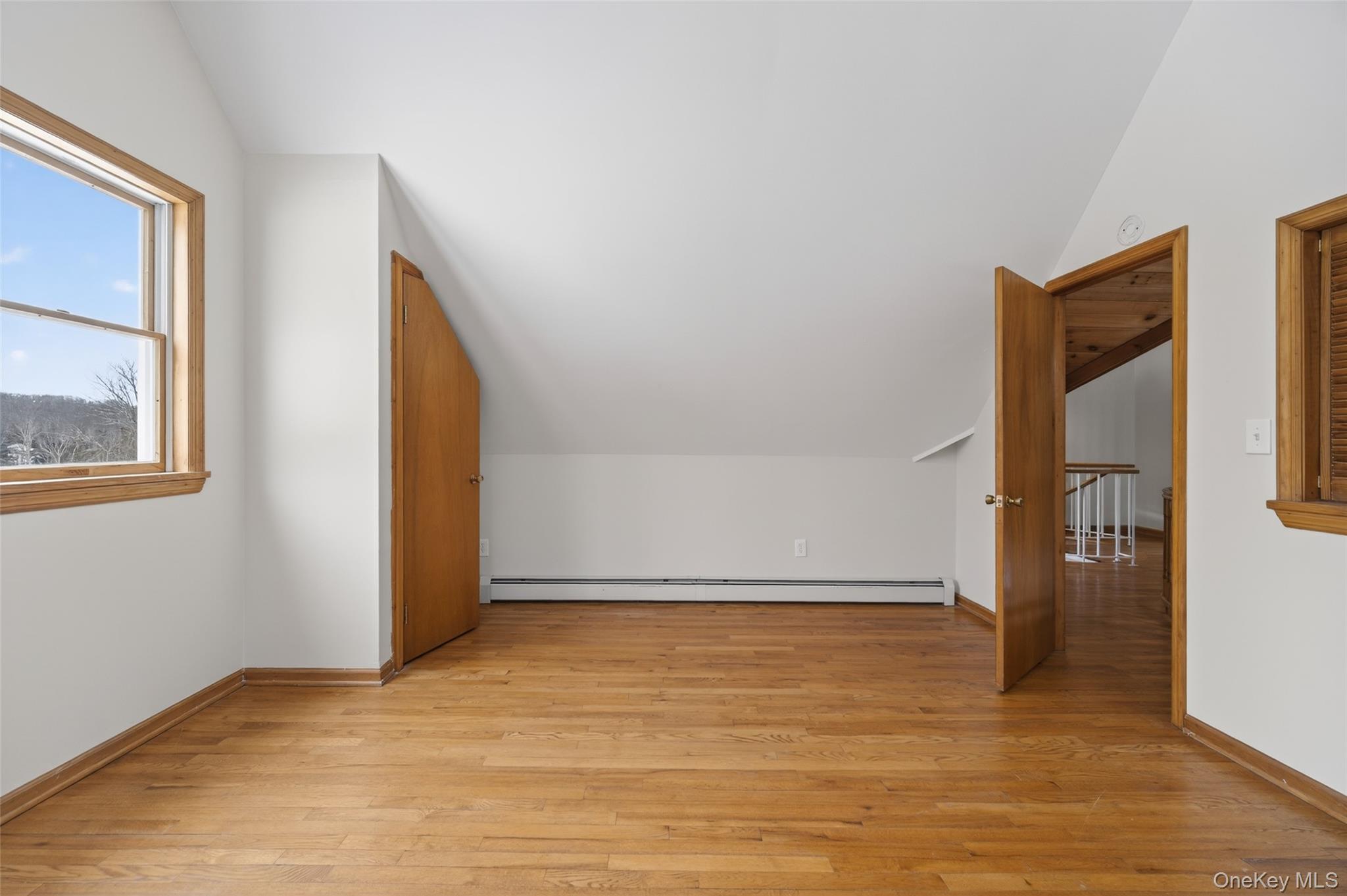 408 Bull Mill Road, Unit 2 Chester, NY 10918 - Photo 21 of 29 a view of an empty room with wooden floor and a window