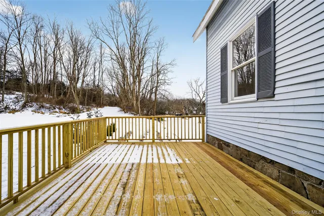 a view of balcony with wooden floor and fence