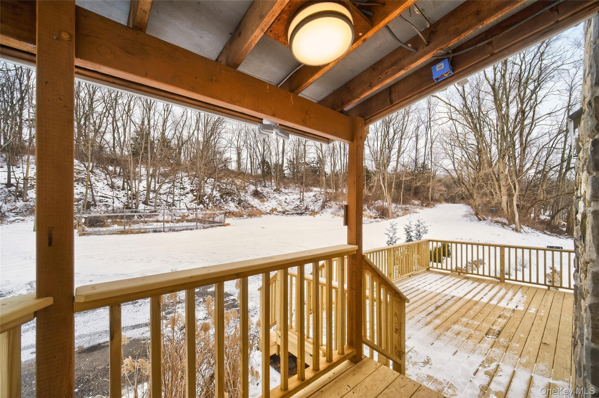 408 Bull Mill Road, Unit 2 Chester, NY 10918 - Photo 4 of 29 a view of balcony with a floor to ceiling window and wooden fence