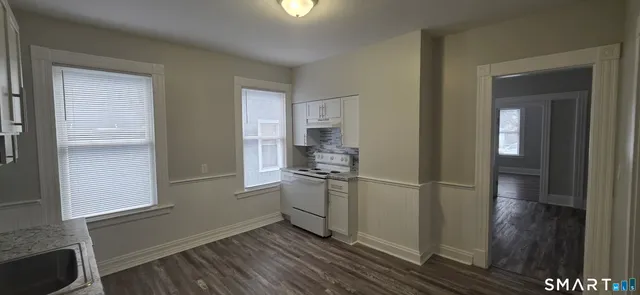a kitchen with a refrigerator and cabinets