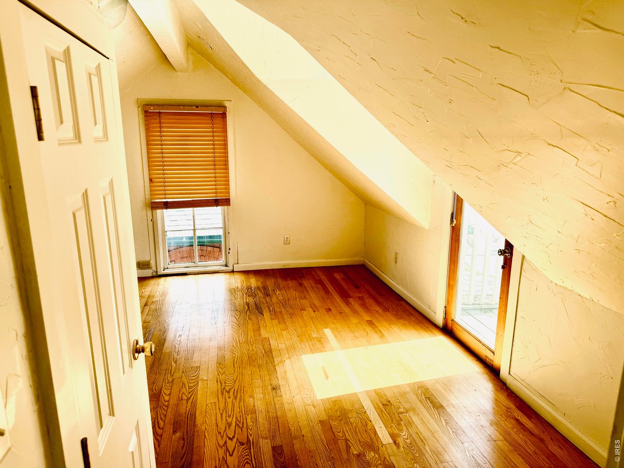1815 17th Street Boulder, CO 80302 - Photo 6 of 8 a view of a room with wooden floor and door