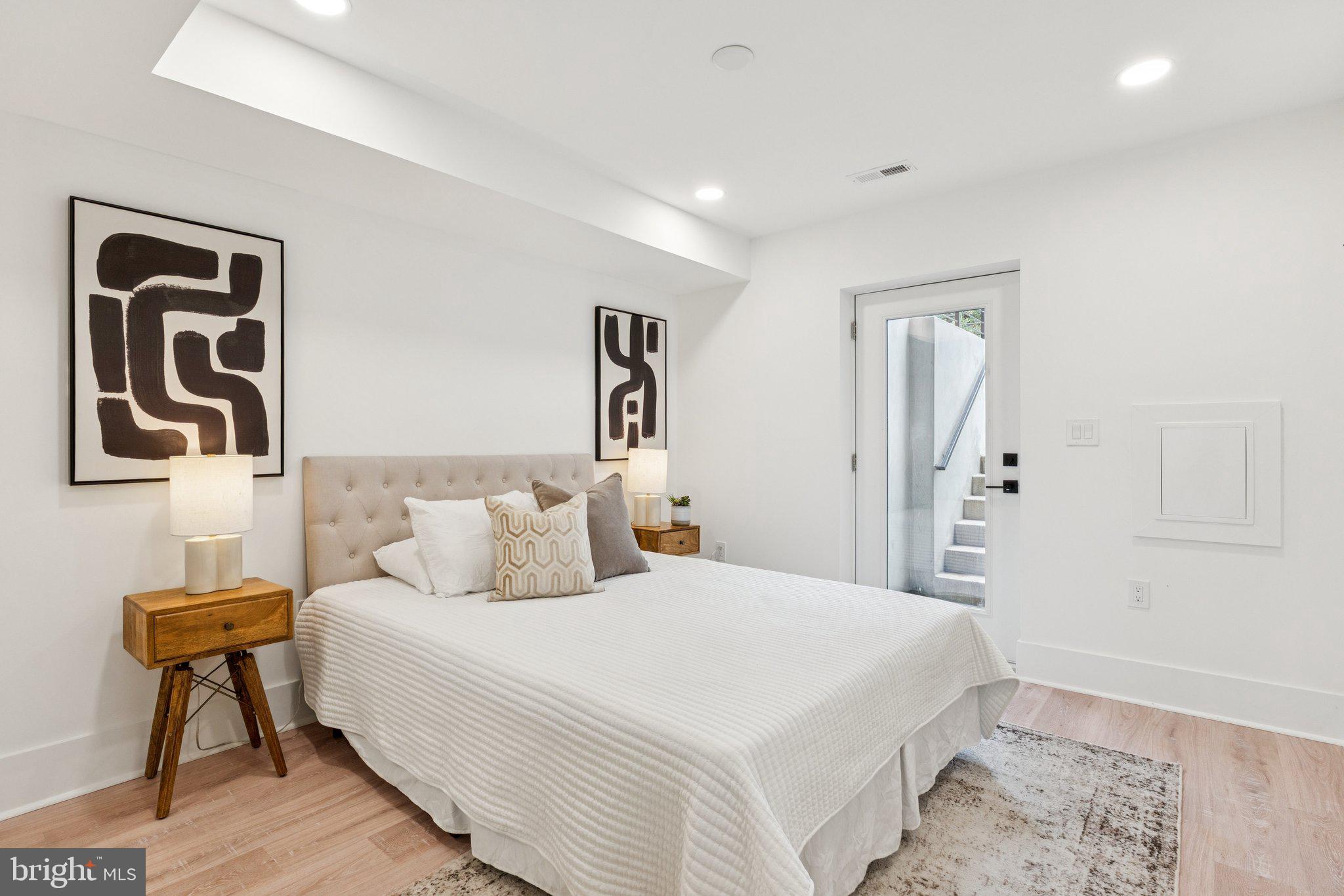 2608 4th Street Northeast, Unit 1 Washington, DC 20002 - Photo 12 of 27 a bedroom with a bed and a lamp