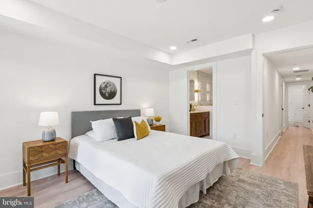 a bedroom with a bed and a lamp on table