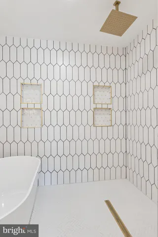 a bathroom with a bathtub and shower