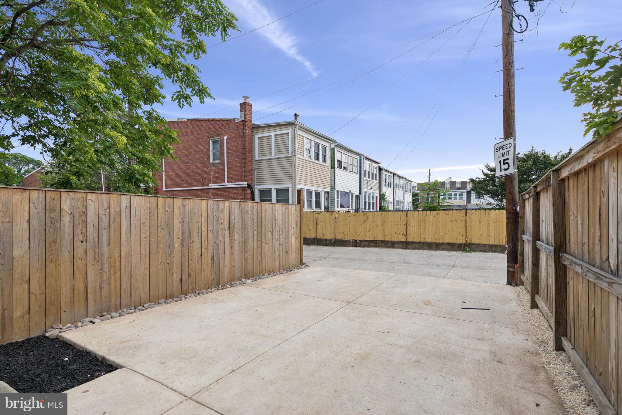 2608 4th Street Northeast, Unit 1 Washington, DC 20002 - Photo 20 of 27 a view of a parking space in front of a house with wooden fence