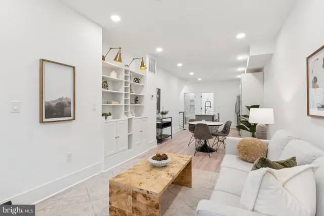 a living room with furniture and a book shelf