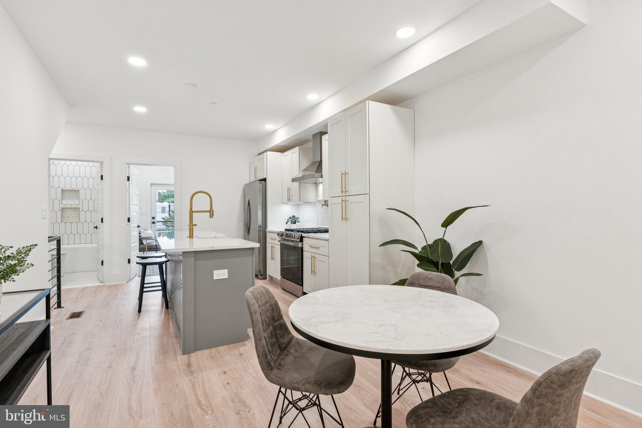 2608 4th Street Northeast, Unit 1 Washington, DC 20002 - Photo 6 of 27 a living room with furniture a potted plant and kitchen view