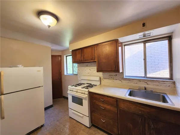 a kitchen with stainless steel appliances a refrigerator sink and cabinets