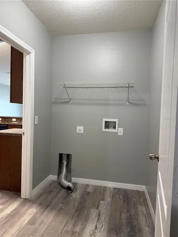 a view of an empty room and wooden floor