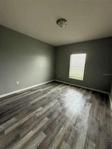 a view of room with window and hardwood floor