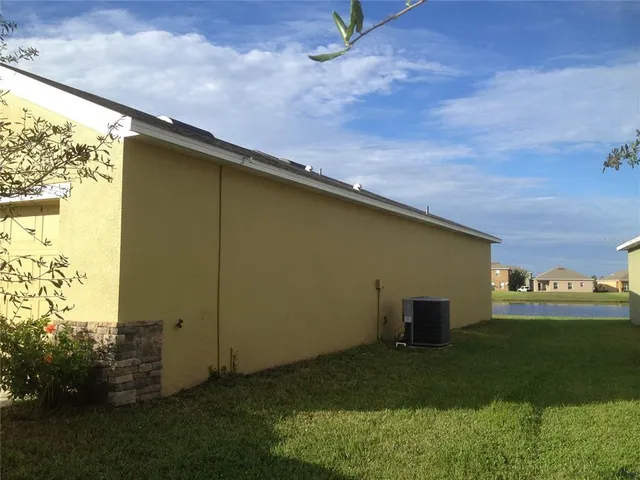 a backyard of a house with lots of green space and outdoor seating