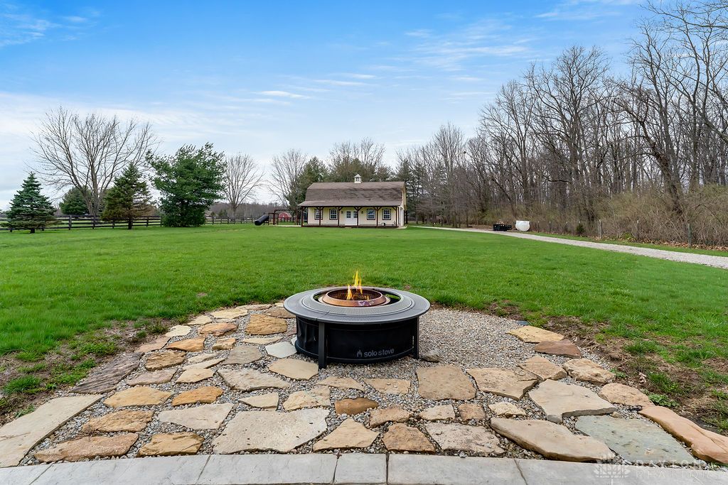 7400 Cook-Jones Road Waynesville, OH 45068 - Photo 57 of 72 This expansive backyard offers ample green space and a dedicated fire pit area for outdoor enjoyment.