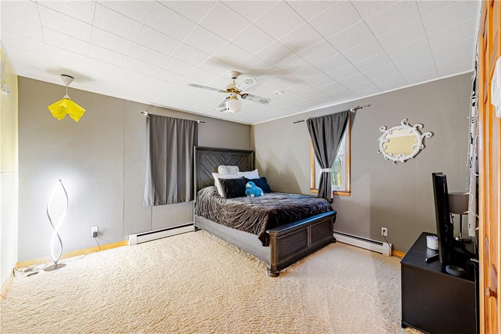 175 Mt Joy Road Mount Pleasant, PA 15666 - Photo 20 of 38 a bedroom with a bed and a chandelier