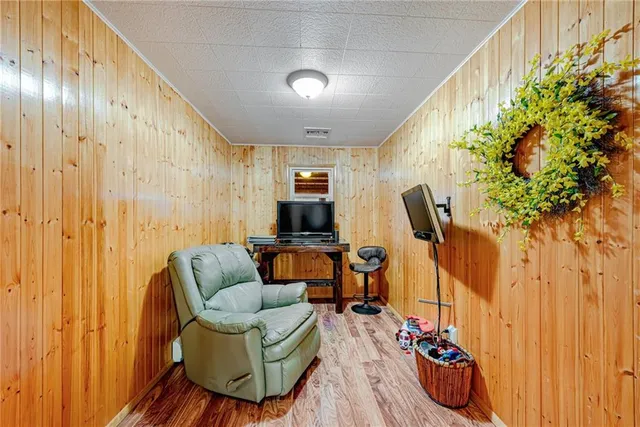 a living room with furniture and a floor to ceiling window
