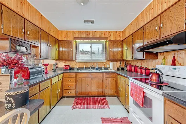 a kitchen with a sink and chairs