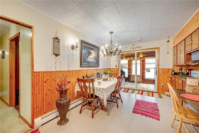 a view of a dining room with furniture and chandelier