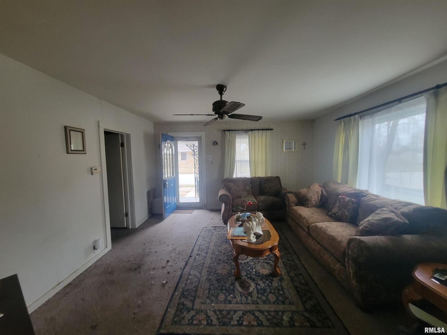 905 West Monroe Street Herrin, IL 62948 - Photo 7 of 14 a living room with furniture and a chandelier