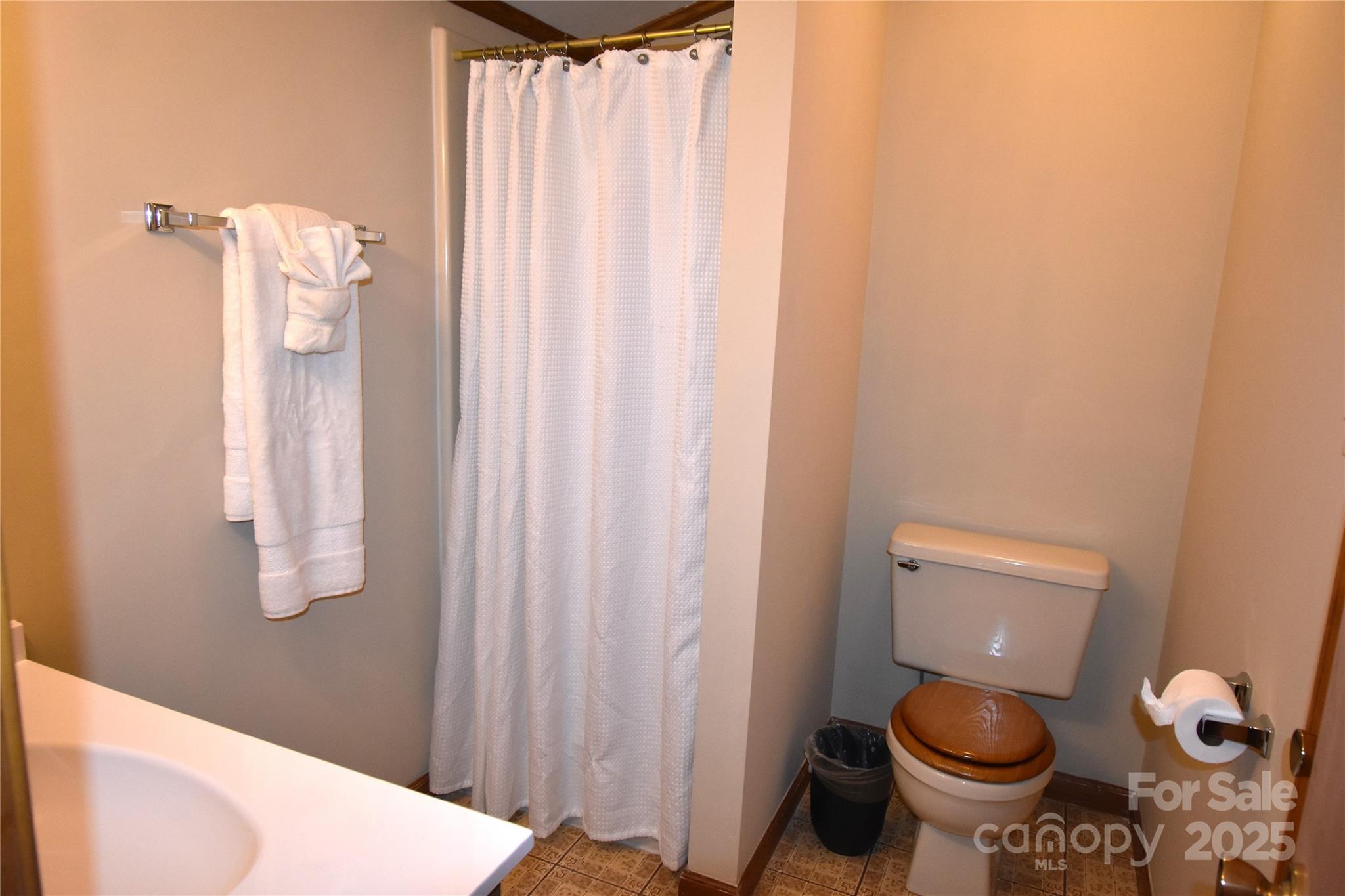 5769 Birch Street Conover, NC 28613 - Photo 24 of 45 a bathroom with a toilet and a shower curtain