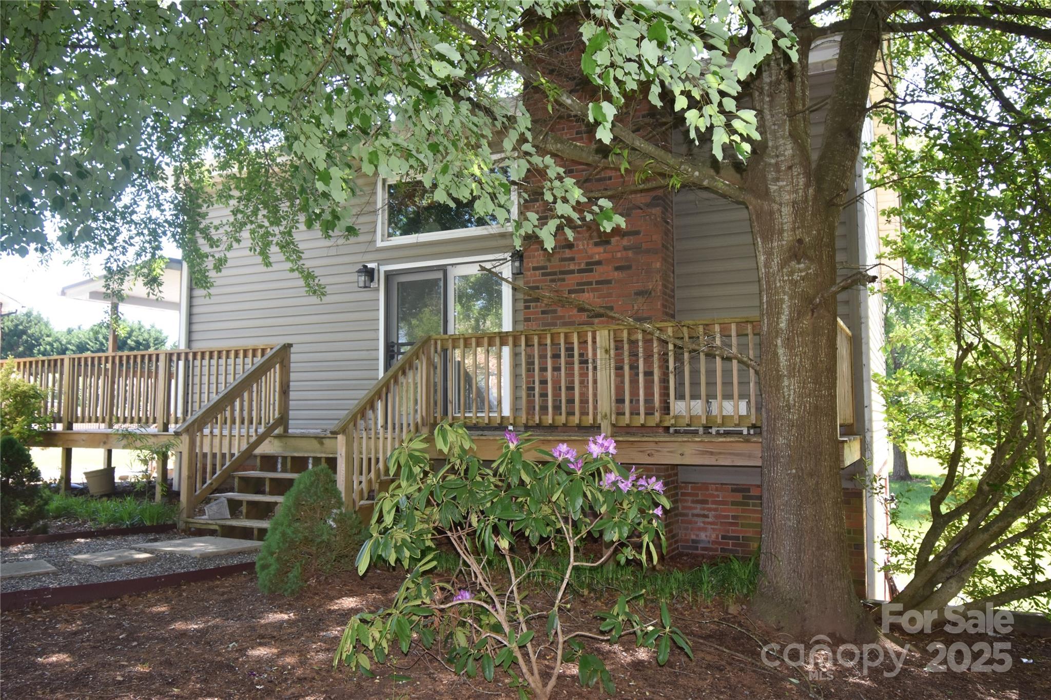 5769 Birch Street Conover, NC 28613 - Photo 44 of 45 a view of a pathway of a house with a flower garden