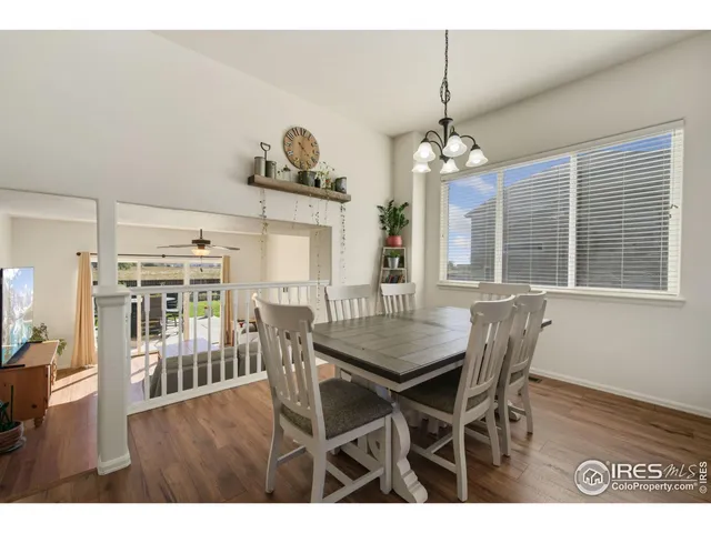 a dining room with furniture window and wooden floor