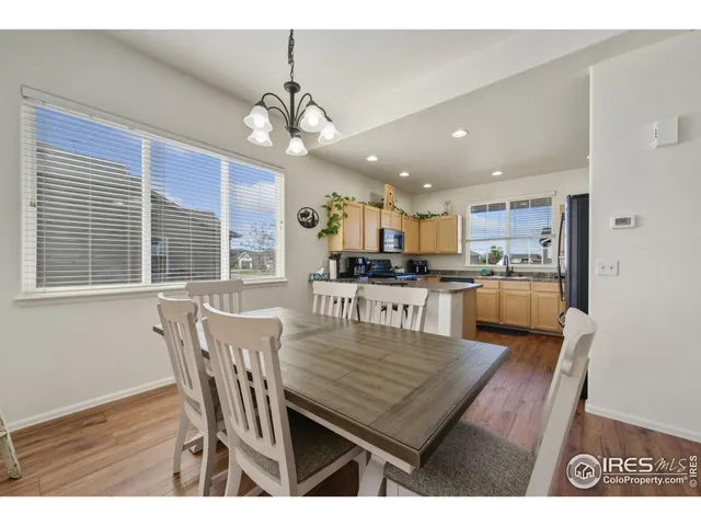 a dining room with furniture and a kitchen view