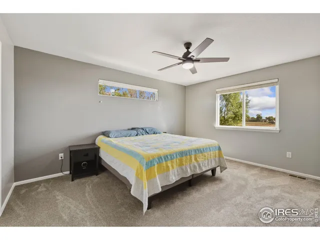 a bedroom with a bed and a painting on the wall