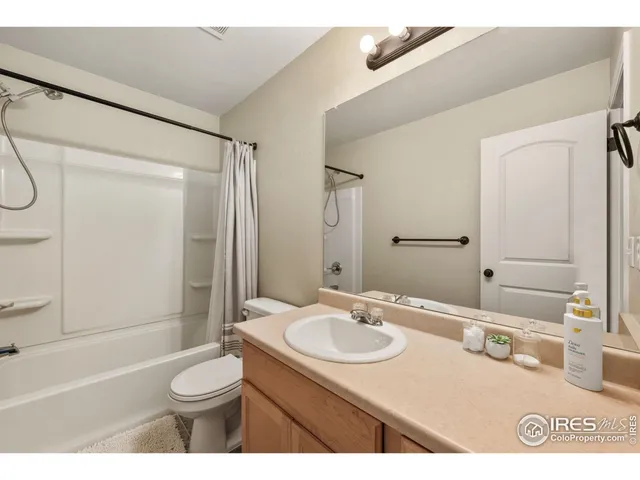a bathroom with a sink toilet vanity and shower