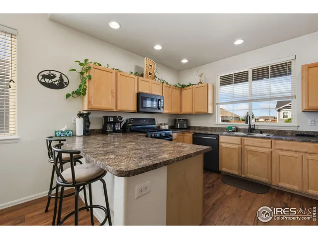 a kitchen with kitchen island granite countertop a sink and counter space