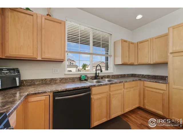 a kitchen with stainless steel appliances granite countertop wooden cabinets a sink and dishwasher