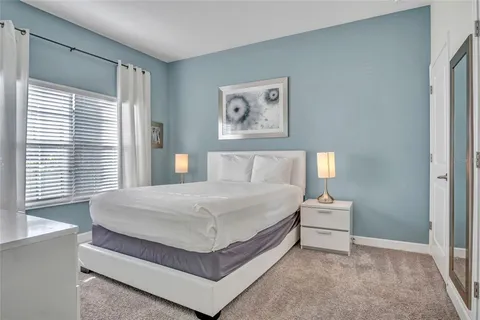 a bedroom with a bed and window