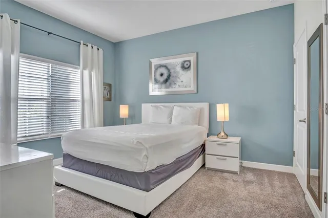 a bedroom with a bed and window