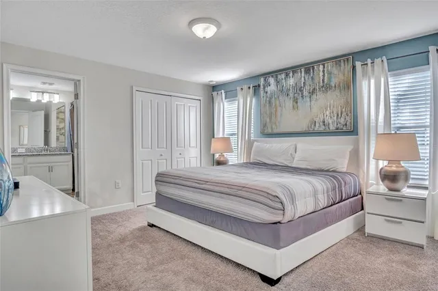 a spacious bedroom with a bed and window