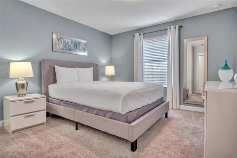 a bedroom with a bed and a painting on the wall